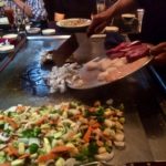 Fresh seafood and meat being added to yep-an grill