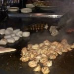 Lobster tails going on the cooktop with scallops, shrimp and chicken at Izumi Steakhouse