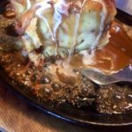 Bubbling sauce on bread pudding plate at Kahootz