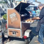 Checking chicken for taste and doneness at Phil and Lou's BBQ