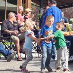 Kids dancing to the music from the bands