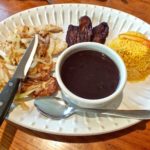 Grilled pork chop with onions and black beans plate