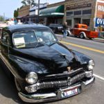 Car with descriptive sign in window at Harrison Haul Ass Show and Shine event. Photo by Sterling Bingham for The Boise Beat