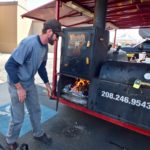 John stoking the fire at Owhyhee BBQ's trailer