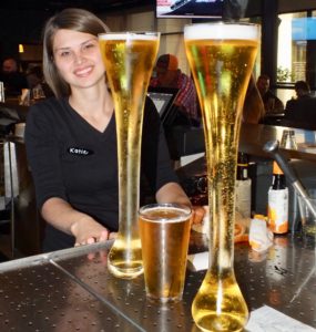 Katie at the bar with a Yard of Beer at the Yardhouse.