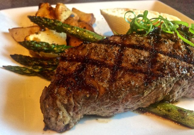 New York Steak and roasted potatoes with asparagus at Kahootz Steak and Alehouse