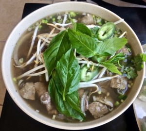 Pho with fresh herbs and bean sprouts