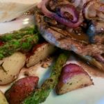 Ribeye Steak, onions, potatoes and asparagus Closeup