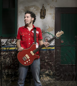 Hamilton Loomis standing with guitar