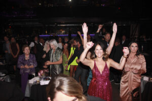 One of the packed tables cheering at the Elijah Rock concert