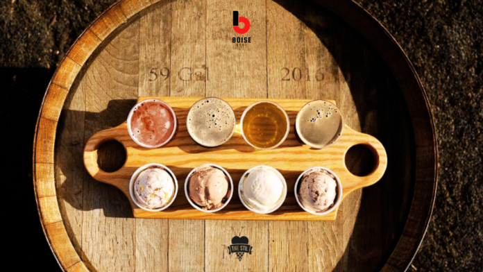 Ice cream and beer samplers in a tray on top of a wooden barrel.