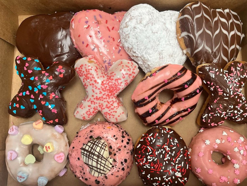 Box of mixed donuts that are Xs and Os, pink, white, and chocolate from Mojo's Donuts and Ice Cream in Meridian, Idaho.