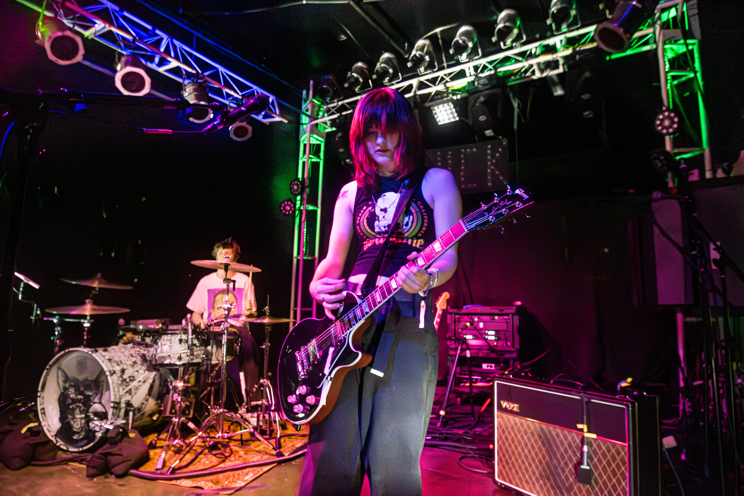 RAUE's lead singer and guitarist passionately performing at a music festival.