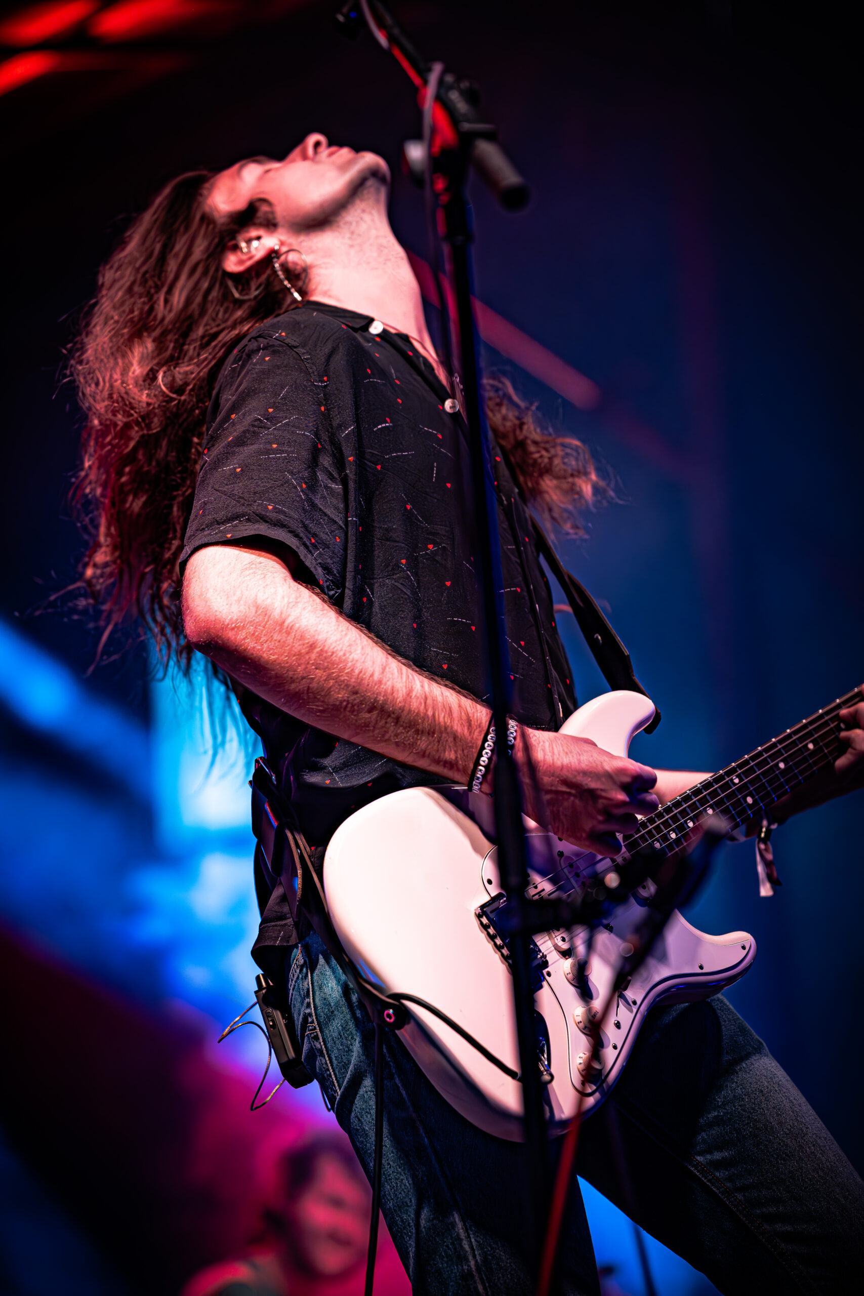 Musician in ecstasy during a guitar solo performance