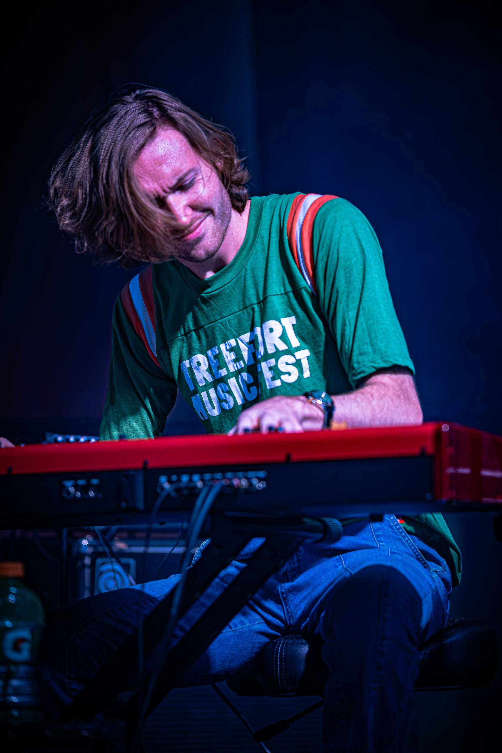 Focused keyboard player performing at a music festival.