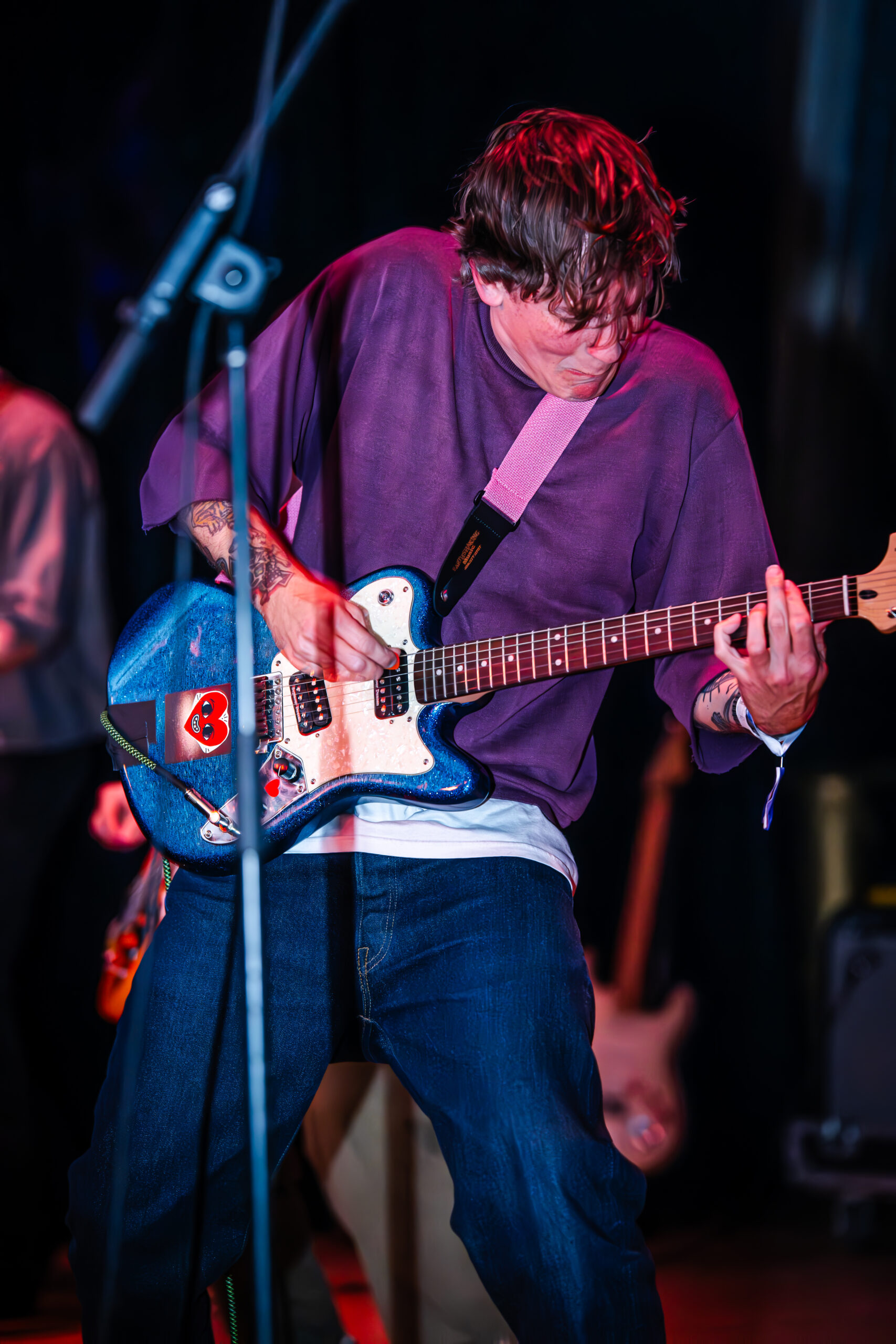 Guitarist performing energetically.