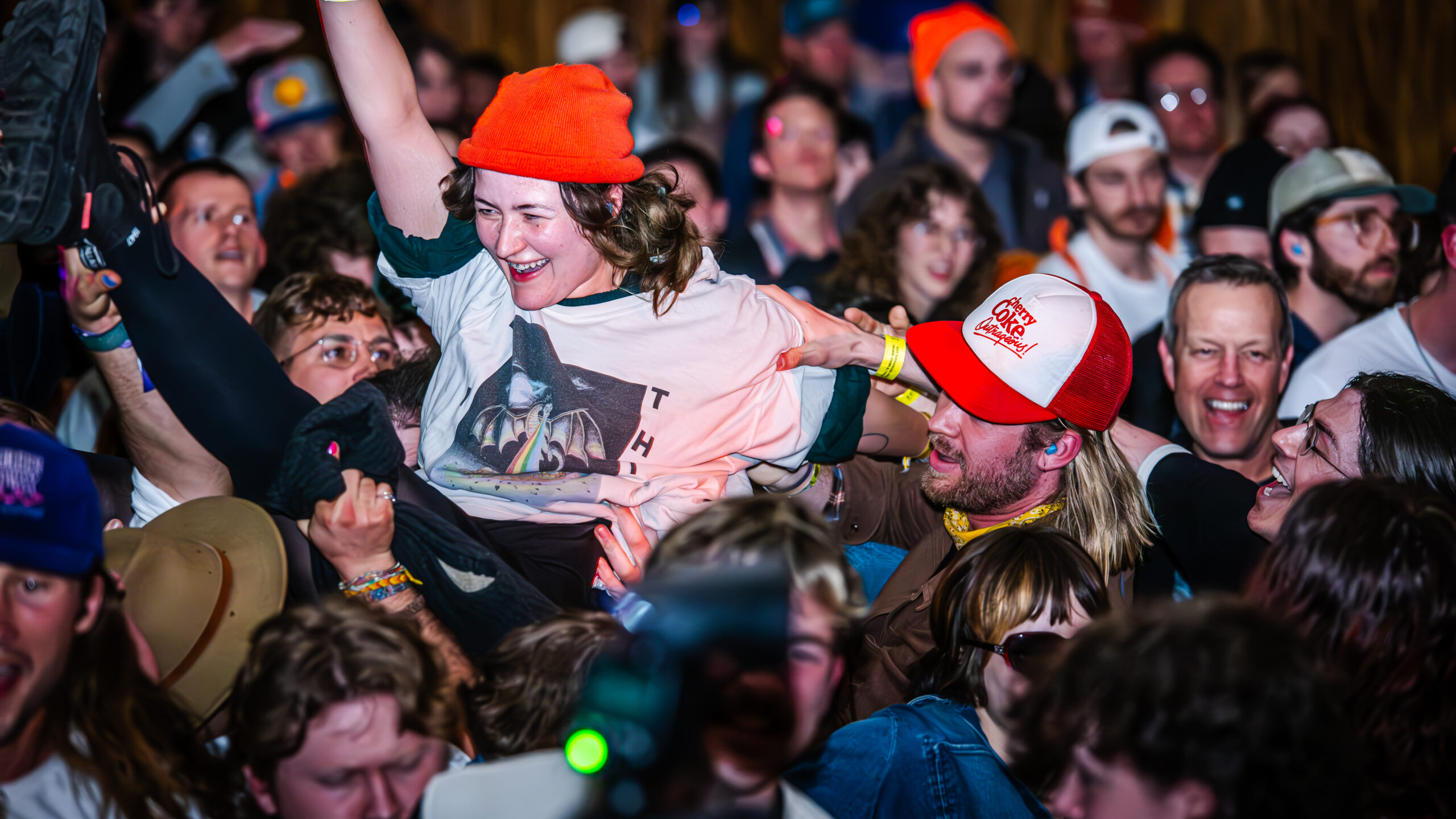 Audience members engaging in crowd surfing.