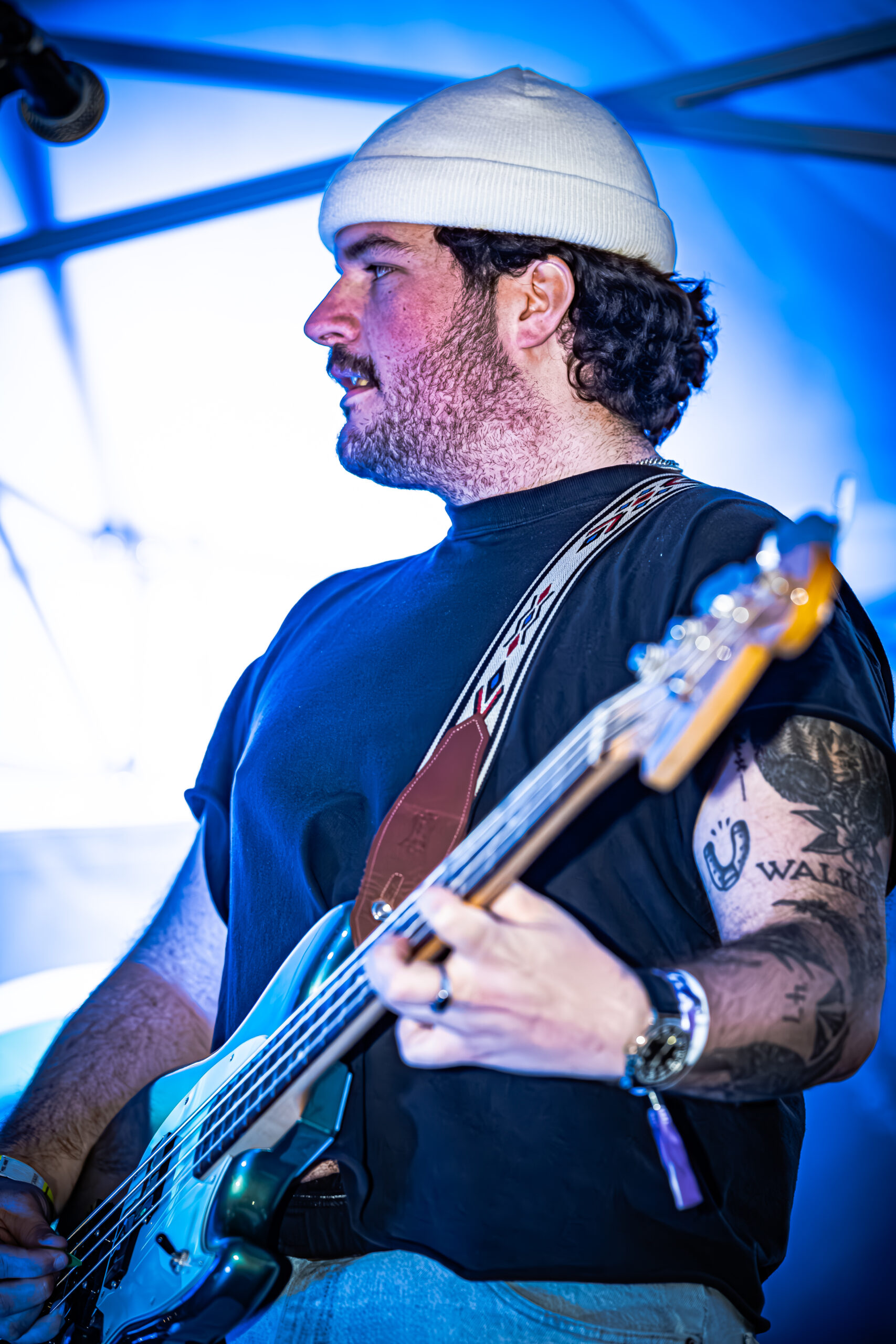 Beau Stablein of Brother Elsey playing bass guitar on stage at a live music event.