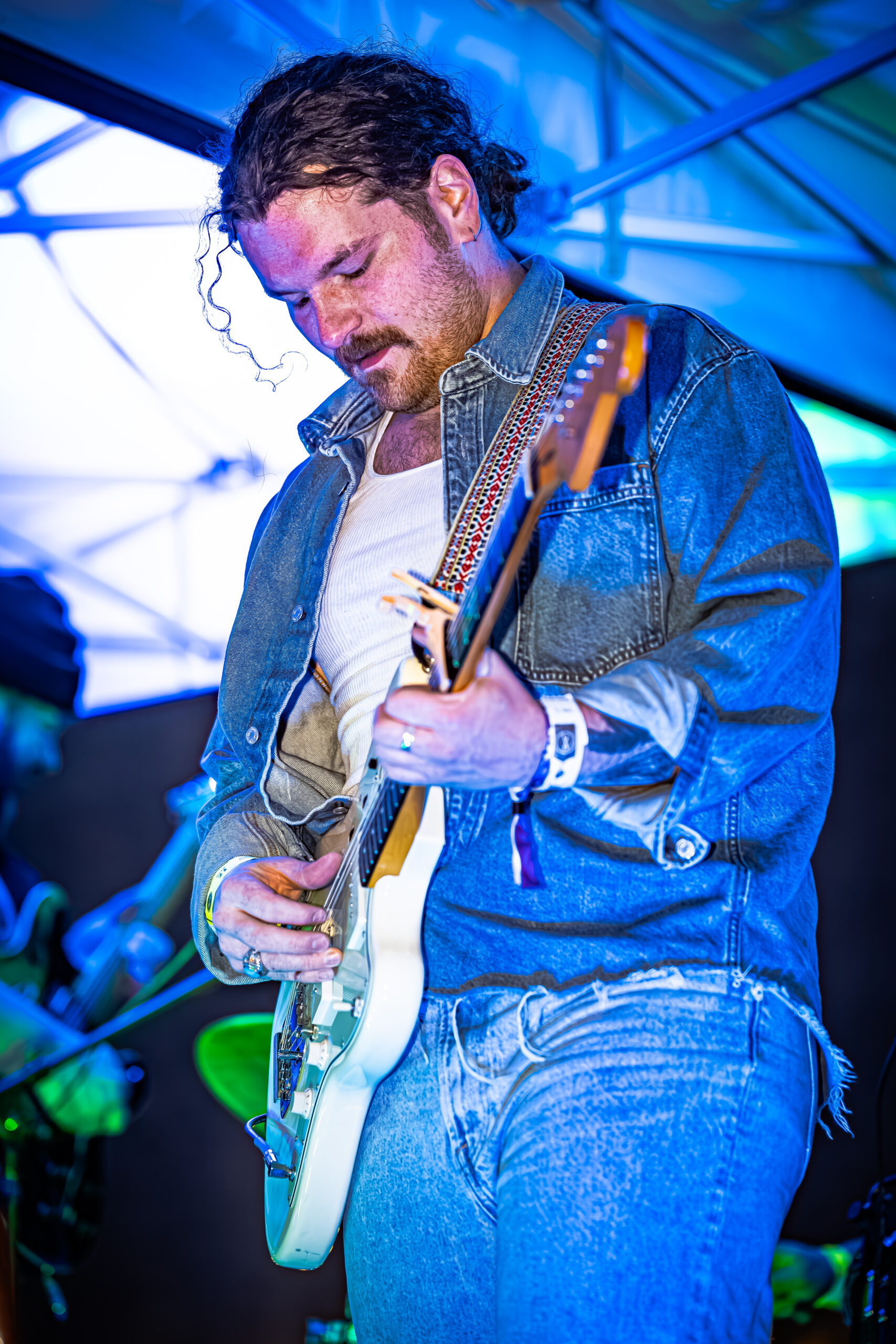 Brady Stablein of Brother Elsey engrossed in playing his guitar during a concert.