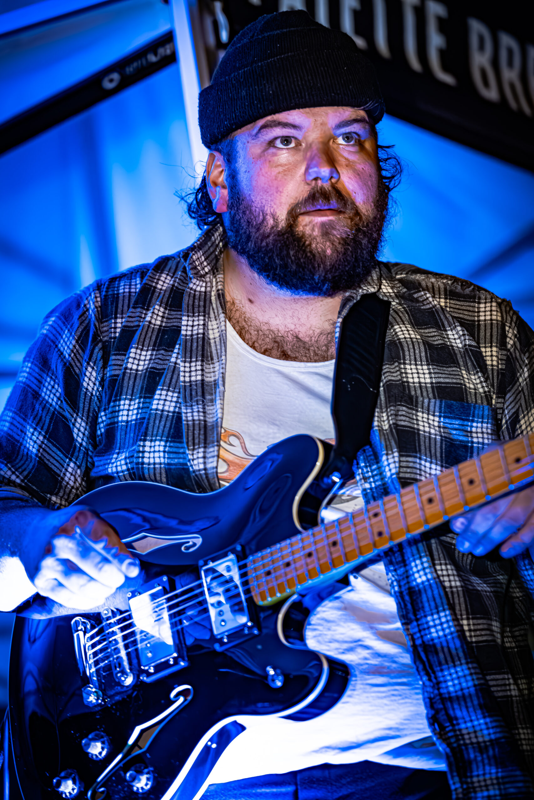 Jack Stablein of Brother Elsey skillfully playing an electric guitar on stage.