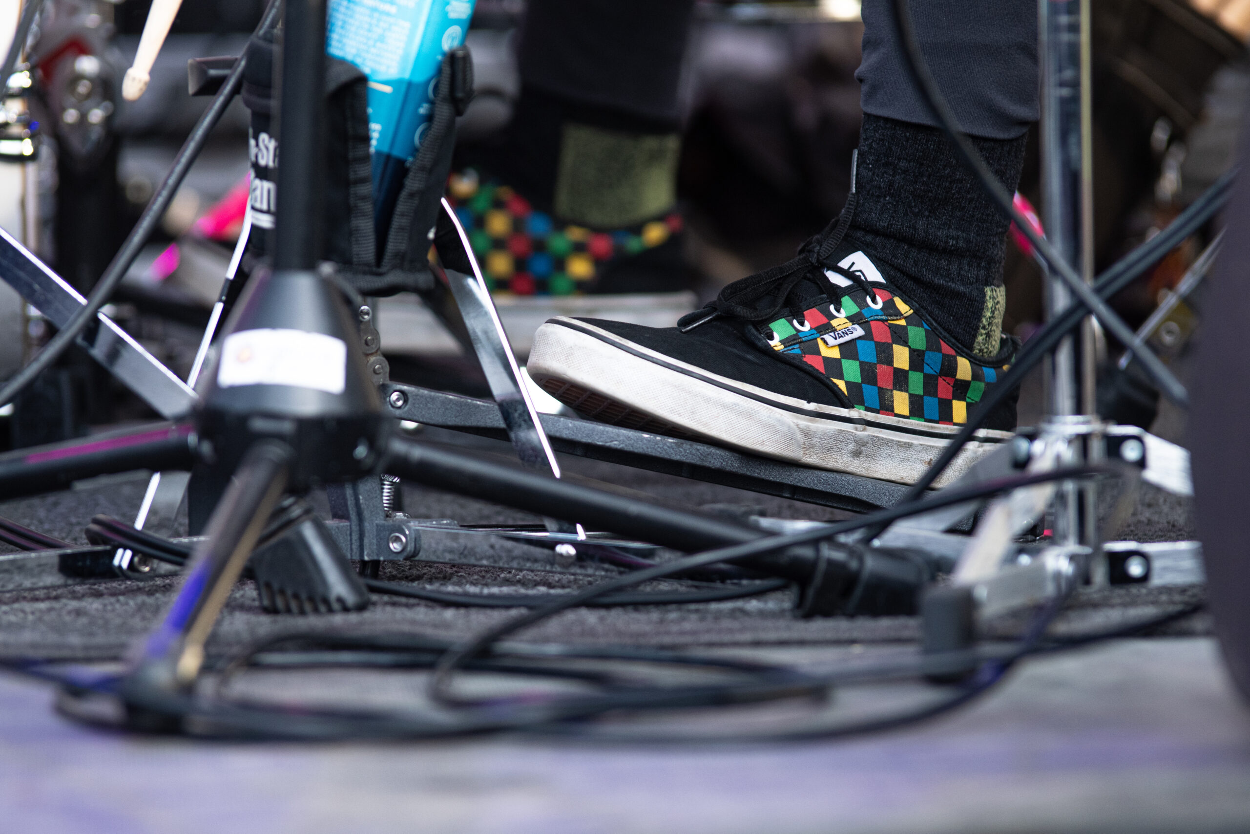 Close-up of a musician's sneakers during a performance.