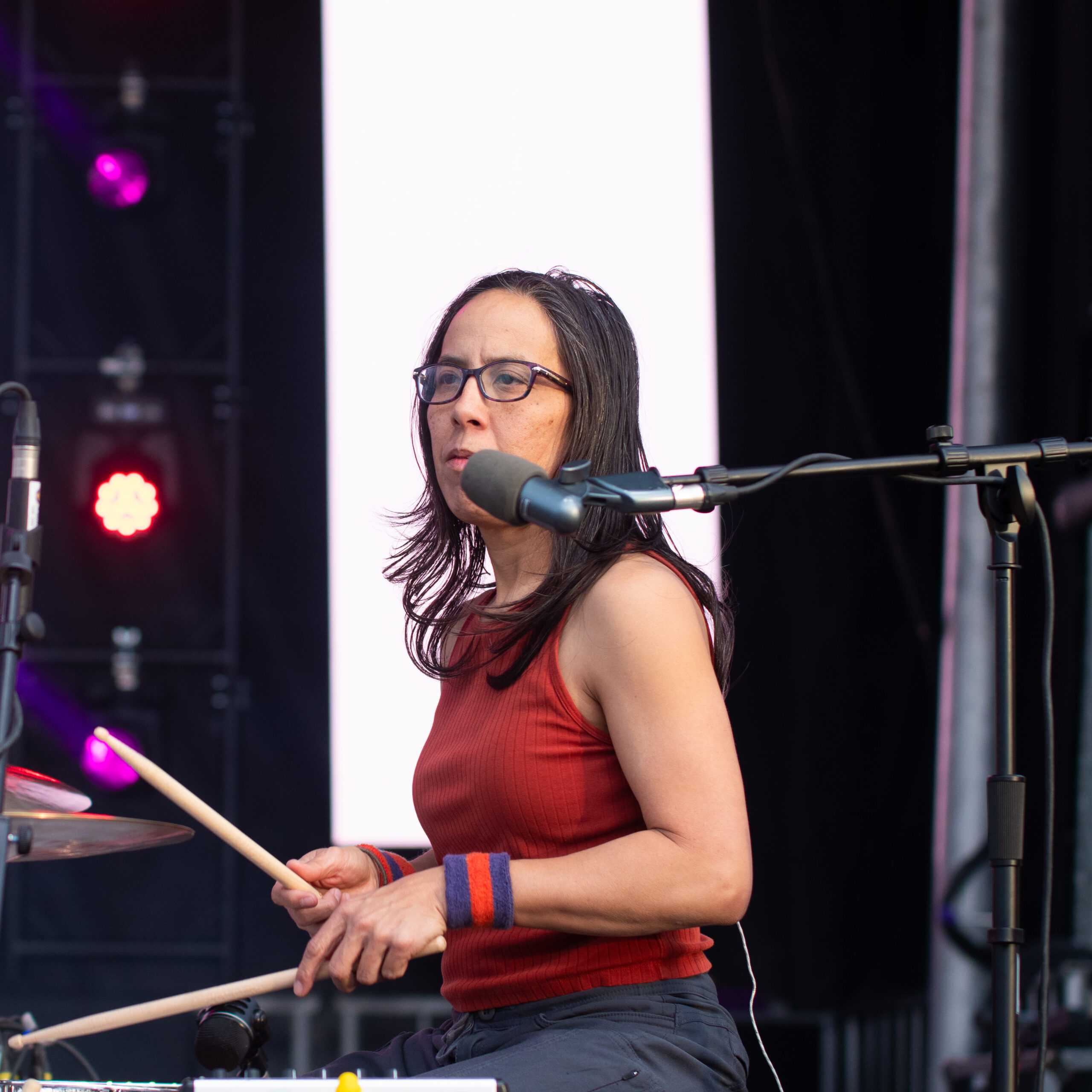 Teresa Esguerra drumming passionately during a live performance.