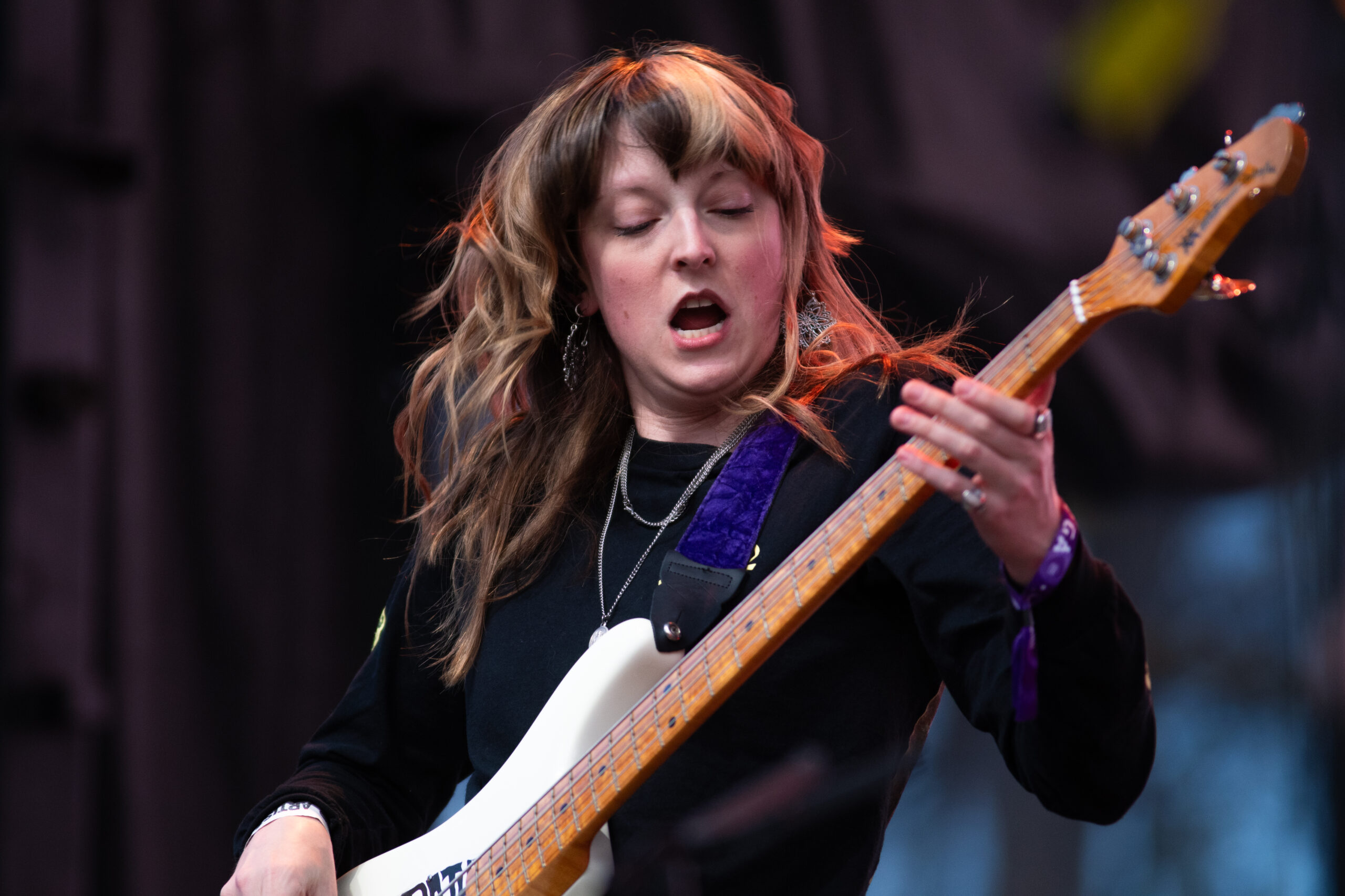 Melanie Radford rocking the bass at a concert.