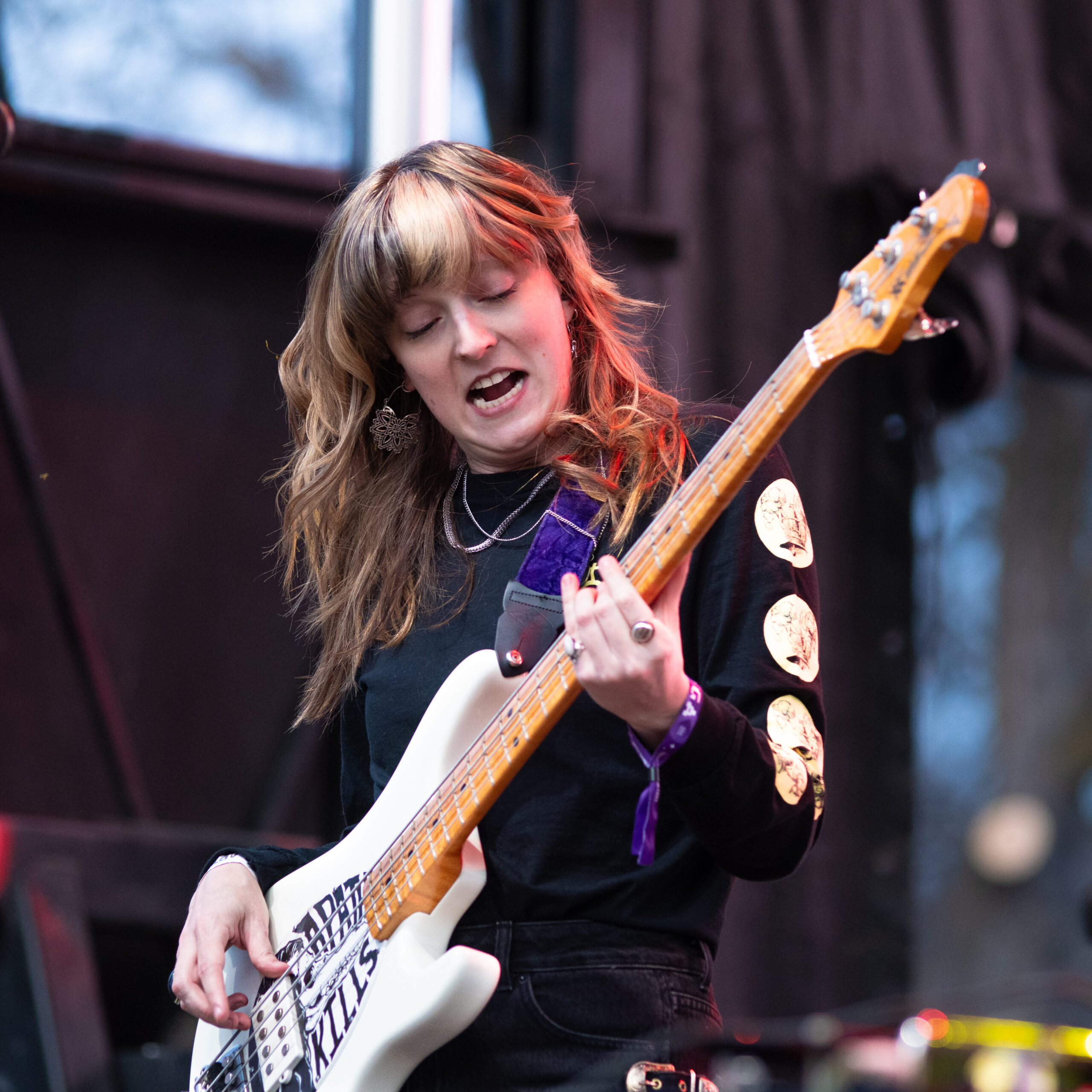 Melanie Radford rocking the bass at a concert.