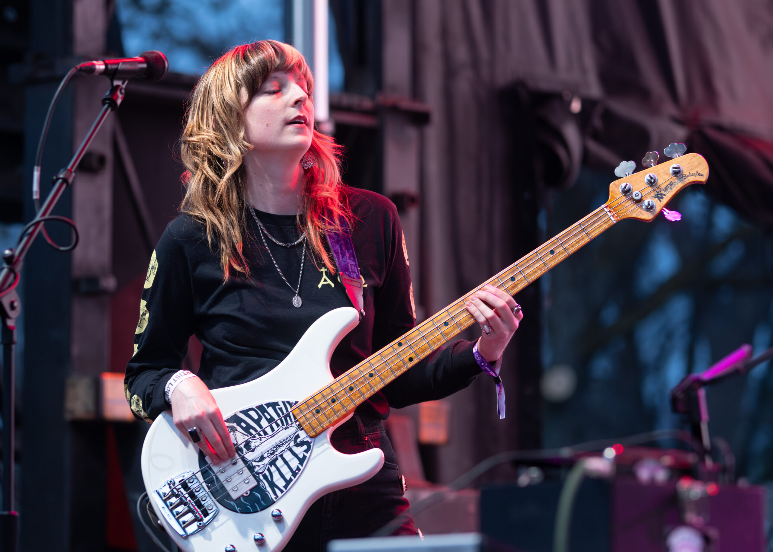 Melanie Radford rocking the bass at a concert.