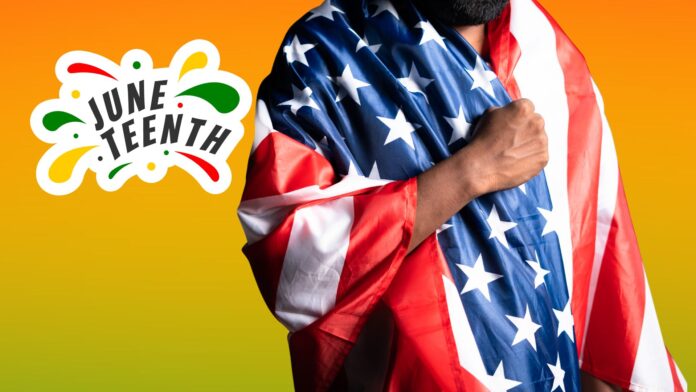 Man wrapped in American flag with Juneteenth logo on an orange and green background.