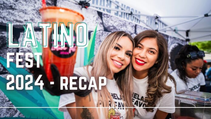 Two smiling women holding a Michelada drink at Latino Fest 2024, with the text 