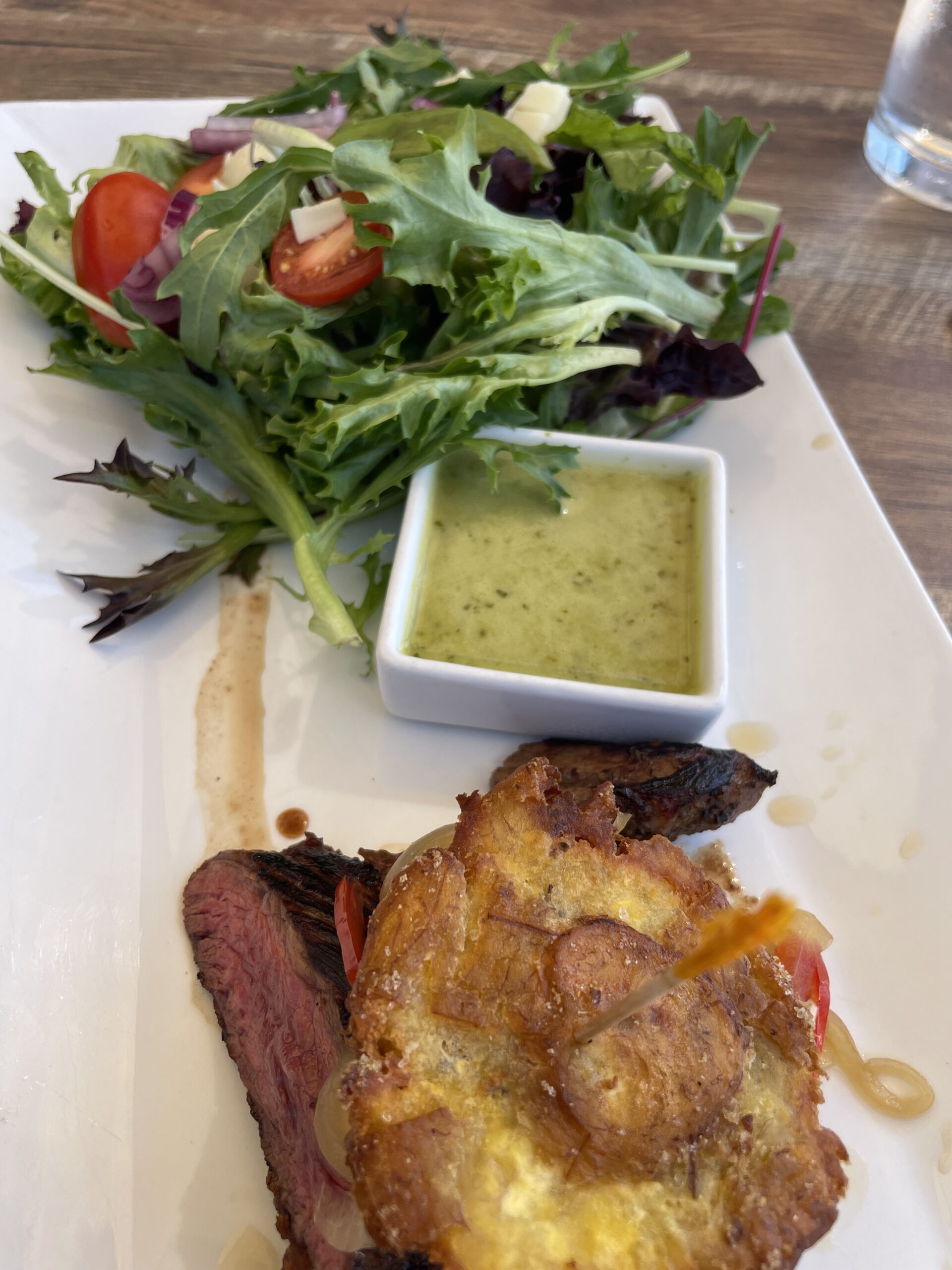 Grilled jibarito with salad and tostones at Wepa Café.