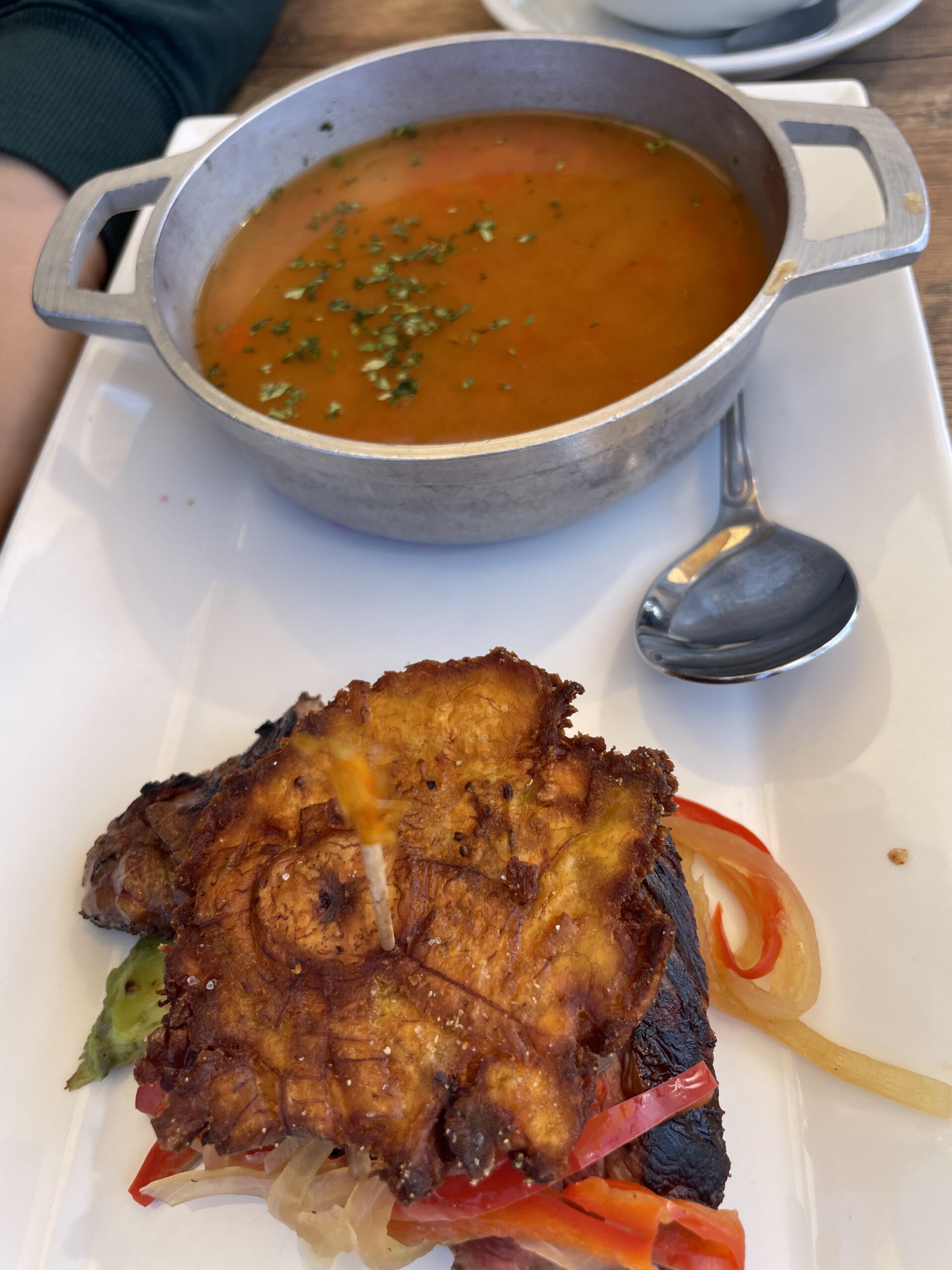 Puerto Rican Bacalao Guisado with grilled steak and tostones at Wepa Café.