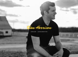 Dan Harrison, a Nashville-based singer-songwriter, sits outdoors in front of a barn wearing a black t-shirt. He is smiling and looking to his right, with a rural landscape in the background. The text "Dan Harrison, Singer-Songwriter" appears across the image in yellow.