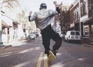 Dancer on an urban street in the middle of the road dancing.