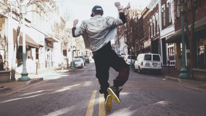 Dancer on an urban street in the middle of the road dancing.