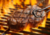 Juicy grilled steak cooking over an open flame on a barbecue grill.