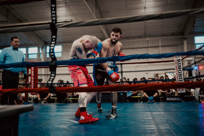 Caldwell Fight Night featuring two fighters with one landing an overhand right.