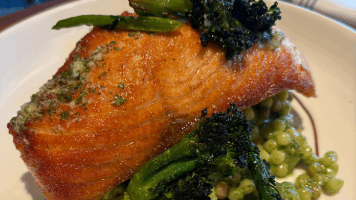 Roasted salmon dish with broccolini and fregola pasta at North Italia in The Village at Meridian