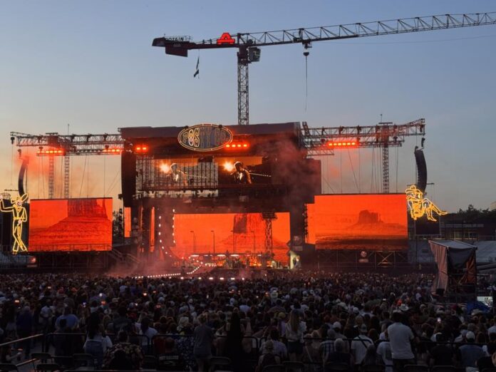 511999402_10237510012867585_9109207516713925225_n Post Malone performs on a brightly lit stage at Albertsons Stadium in Boise as a massive crowd watches under a sunset sky.