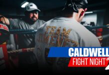 Robert Jimenez III Returns to the Ring | Caldwell Fight Night 2 Main Event Spotlight Professional boxer wearing a "Team Jimenez" shirt prepares in the boxing ring for Caldwell Fight Night 2, with his coach in the background.