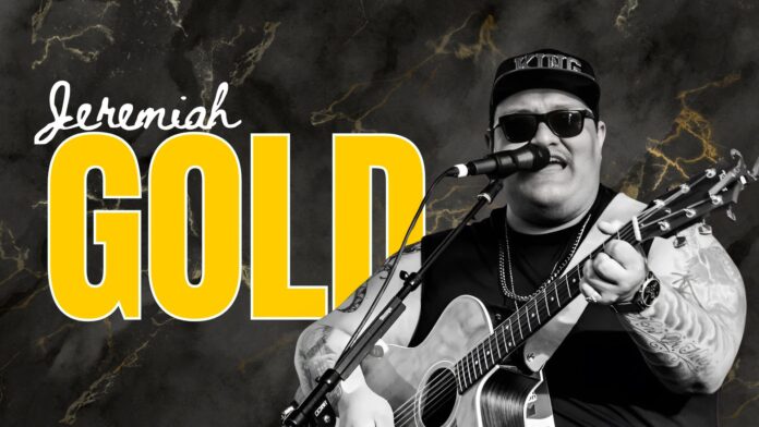 Jeremiah Gold Jeremiah Gold performing live with guitar and microphone, wearing sunglasses and a hat that says “KING,” against a black marble background with bold yellow text.