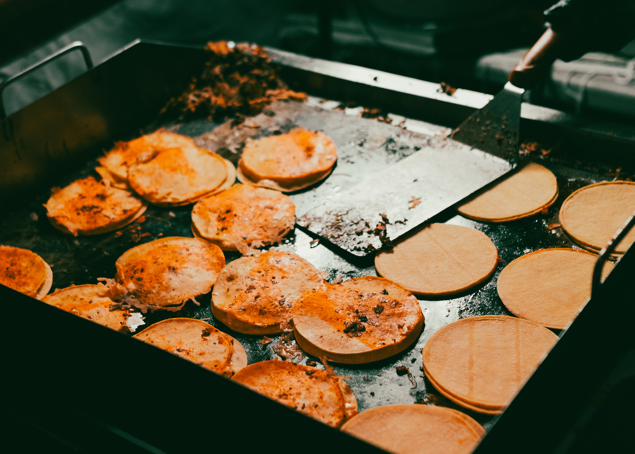 Fresh tacos cooking on a hot griddle at Gallos Tacos food truck in Boise, Idaho.