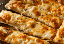 Why Ruszoni’s Pizza Should Be On Your Idaho Pizza Hit List (And Their Sandwiches Might Be Even Better) Cheesy garlic breadsticks with melted mozzarella and herbs served on a wooden board