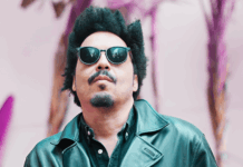 Chavar Dontae Interview | From Midwest Roots to LA Stages & the Too Much EP Chavar Dontae wearing sunglasses and a leather jacket, posing outdoors with a confident look in front of a vibrant backdrop.