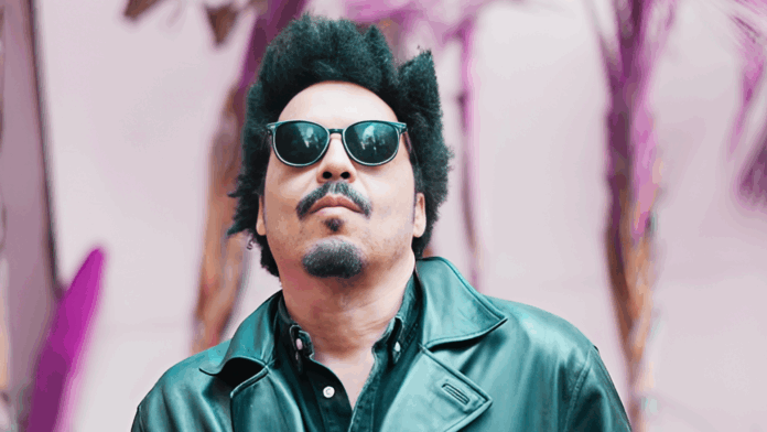 Chavar Dontae 3 Chavar Dontae wearing sunglasses and a leather jacket, posing outdoors with a confident look in front of a vibrant backdrop.