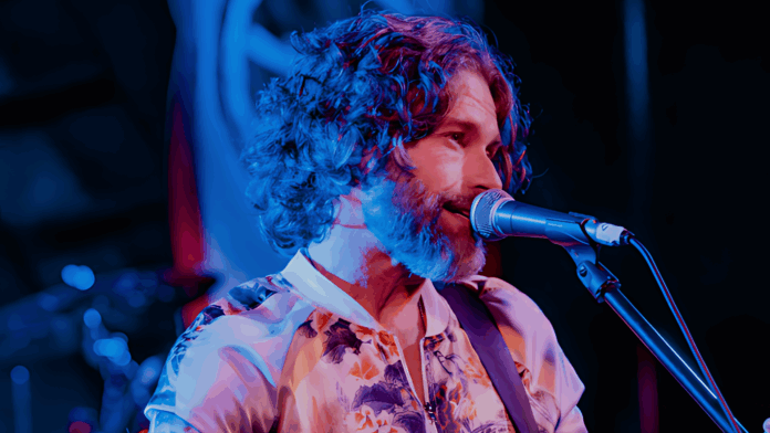 Dustin Morris - Thumbnail Dustin Morris performing live on stage, singing into a microphone with passion and emotion during his Some Kind of Magic album release performance.