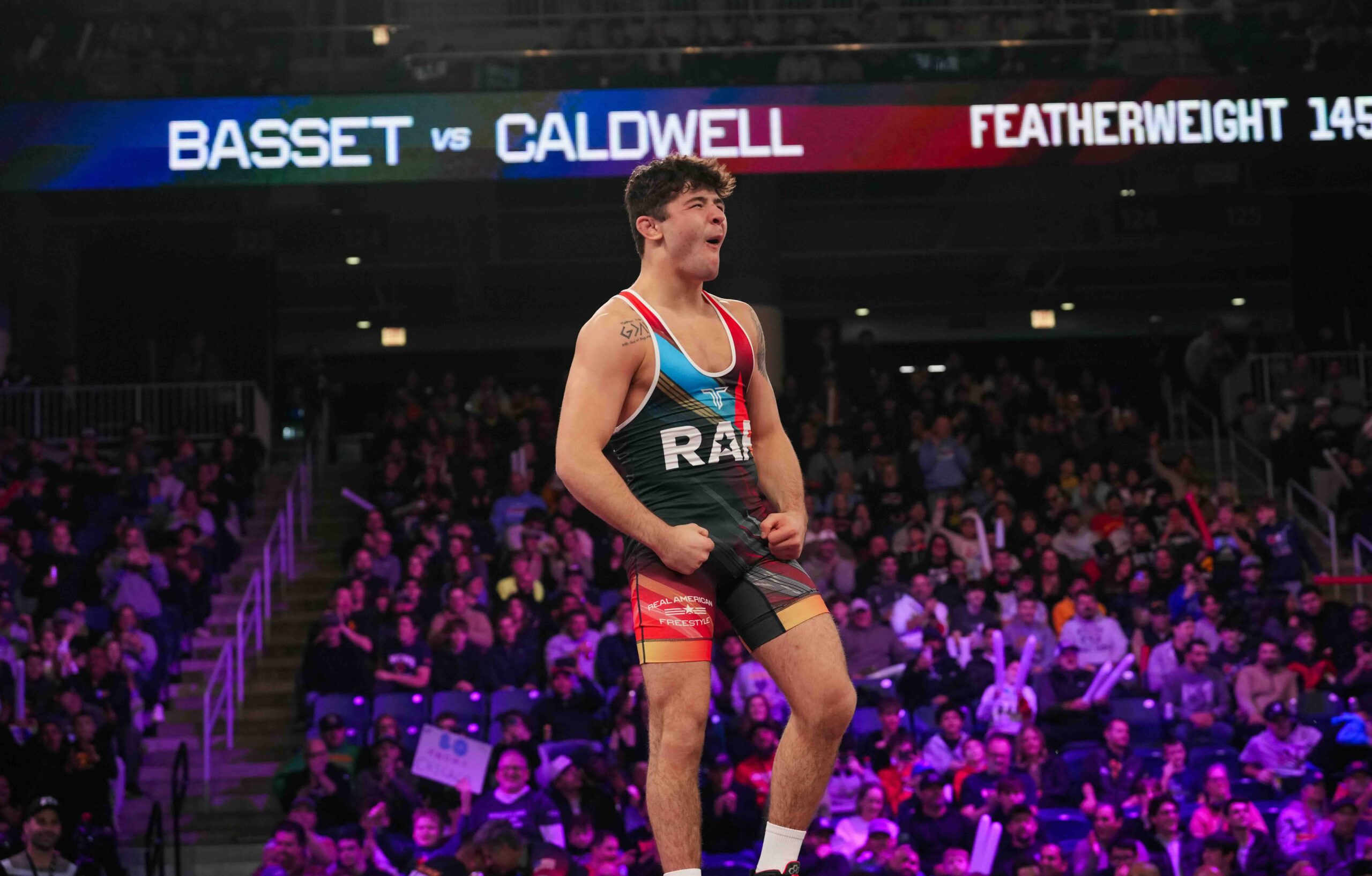 Bo Bassett celebrates after defeating Darrion Caldwell by fall during their featherweight 145 lb matchup at RAF 03 in Chicago.