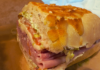 Fratelli Deli: Boise’s Italian-Style Sandwich Haven Serving Tradition One Stack at a Time Close-up of Fratelli Deli’s Godfather sandwich on house-baked Dutch Crunch bread, layered with Italian meats, provolone, lettuce, tomato, and spicy giardiniera.