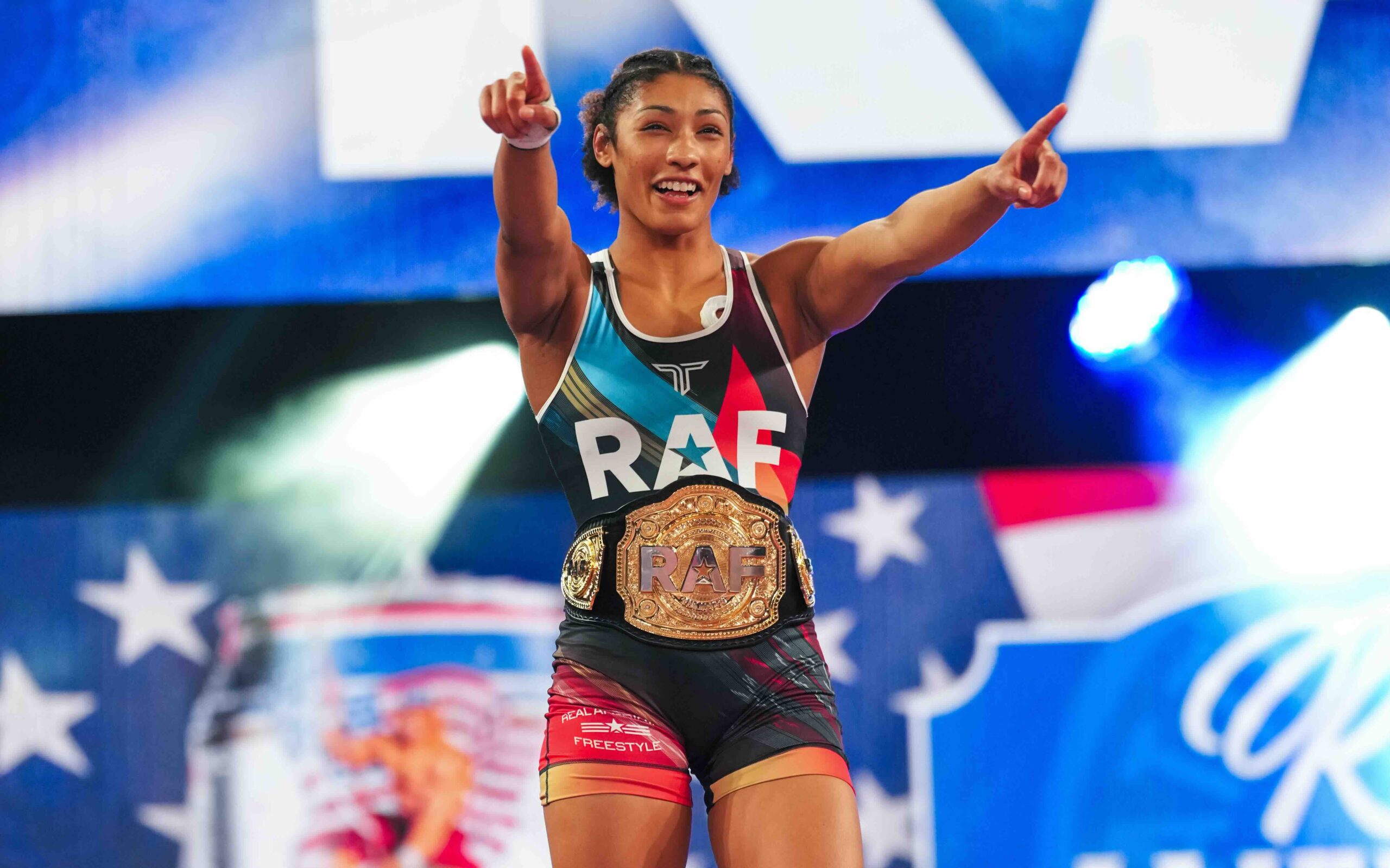 Kennedy Blades points to the crowd while wearing the RAF championship belt after winning the women’s 145 lb title at RAF 03.
